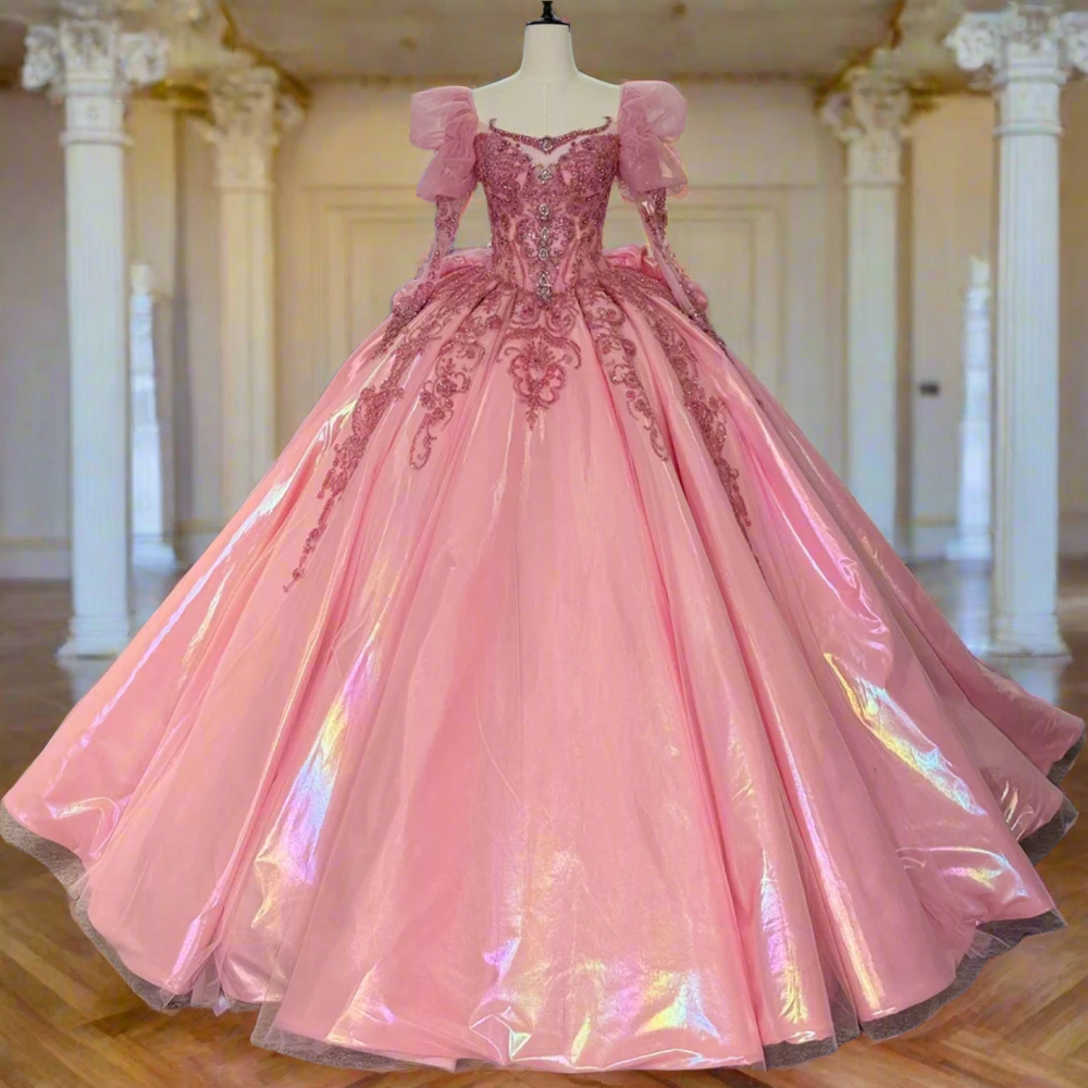 Pink evening gown on a mannequin with other dresses in the background