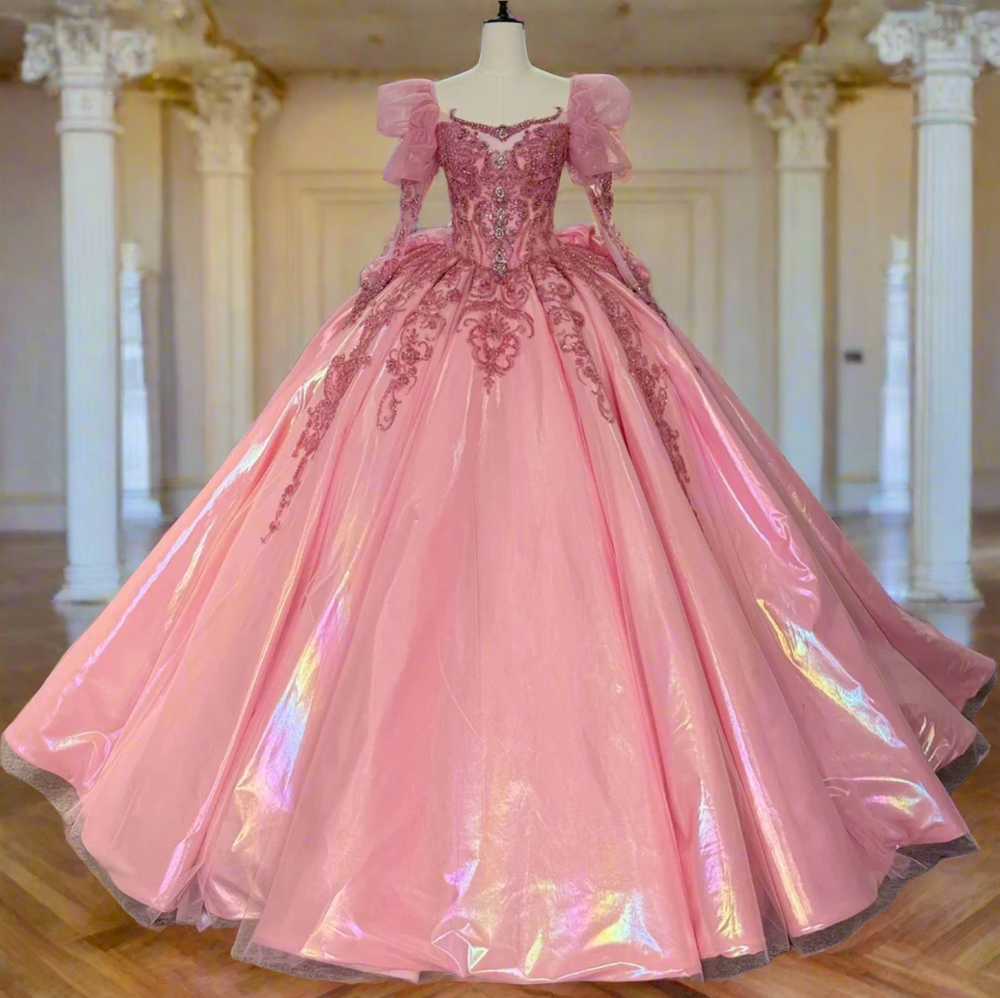 Pink evening gown on a mannequin with other dresses in the background