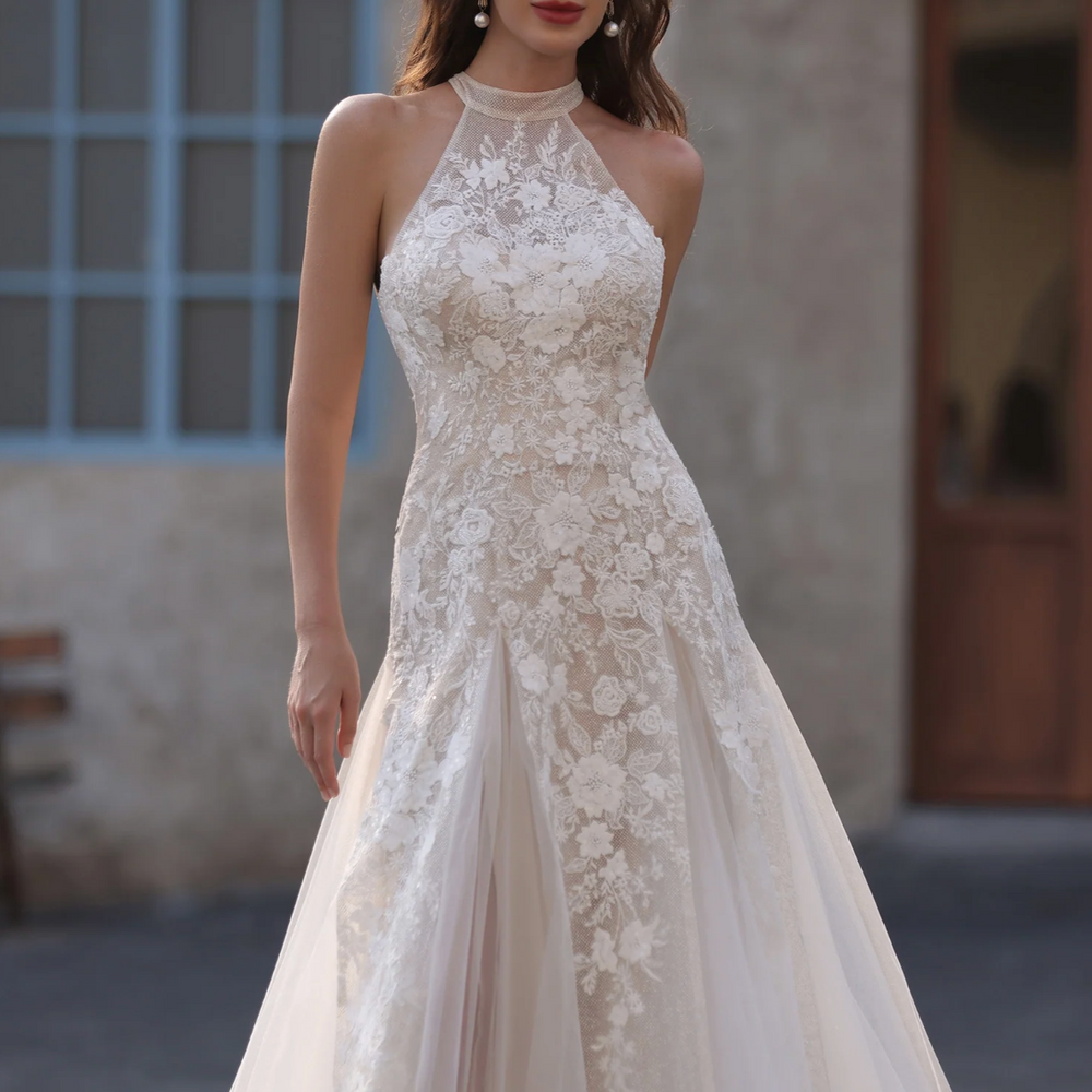 
                      
                        Woman wearing a lace wedding dress with a blurred background
                      
                    