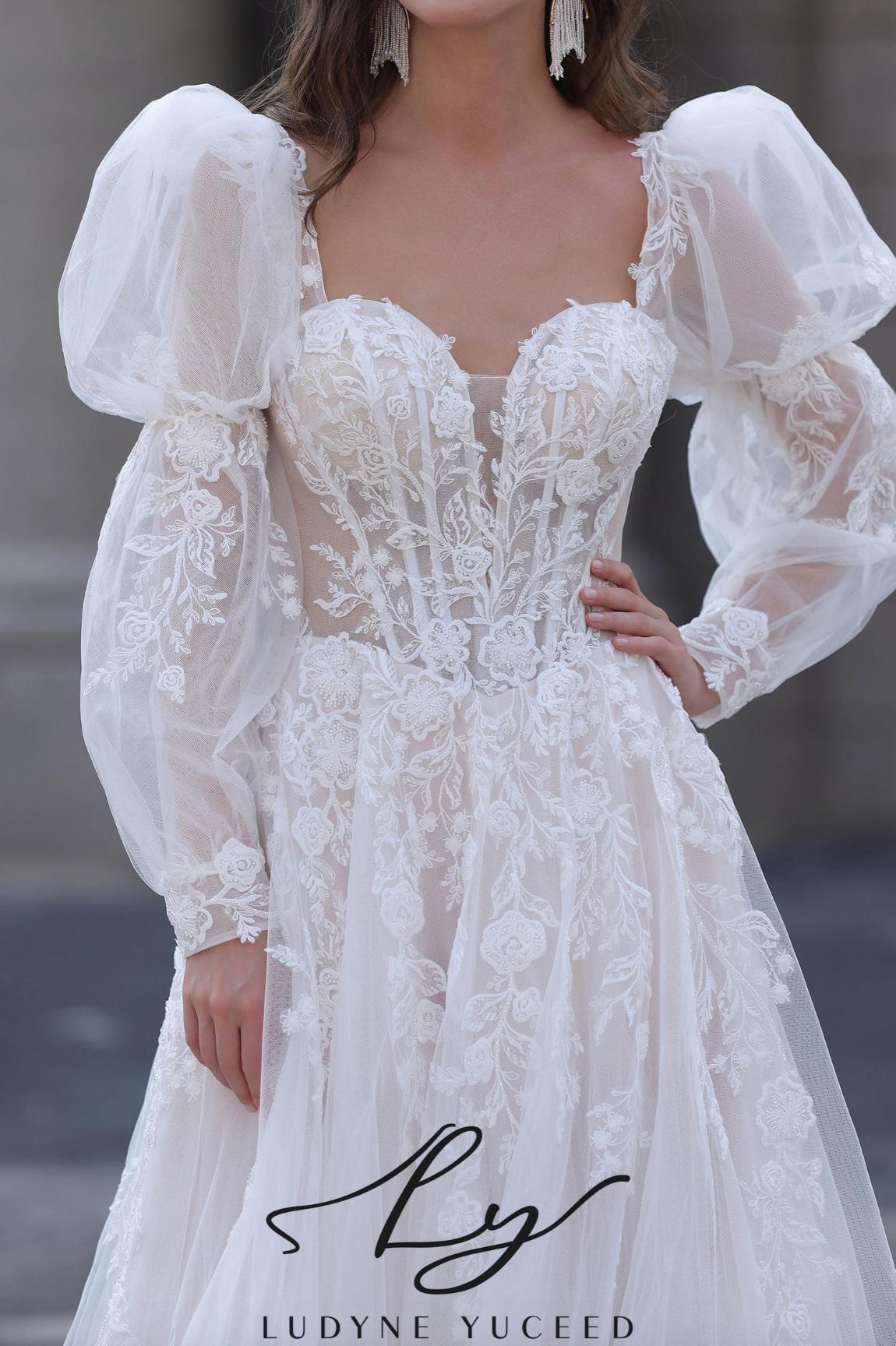 Elegant white lace dress with puffed sleeves, featuring the brand 'Ludyne Yuceed'.