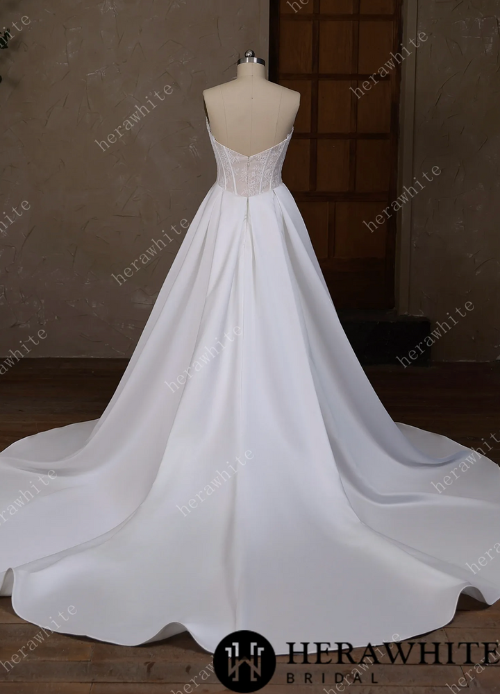 
                      
                        Satin Wedding Dress Irregular Neckline Basque Waistline Bridal Gown, this strapless wedding dress captivates with its distinctive irregular neckline
                      
                    