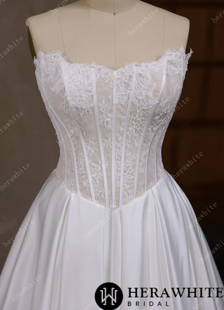 
                      
                        Satin Wedding Dress Irregular Neckline Basque Waistline Bridal Gown, this strapless wedding dress captivates with its distinctive irregular neckline
                      
                    
