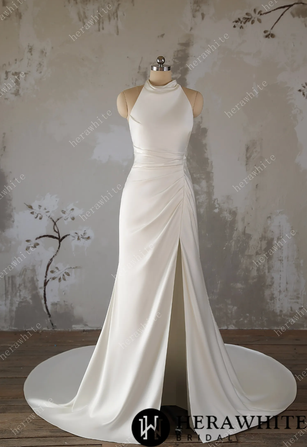 White wedding dress on a mannequin against a textured wall background