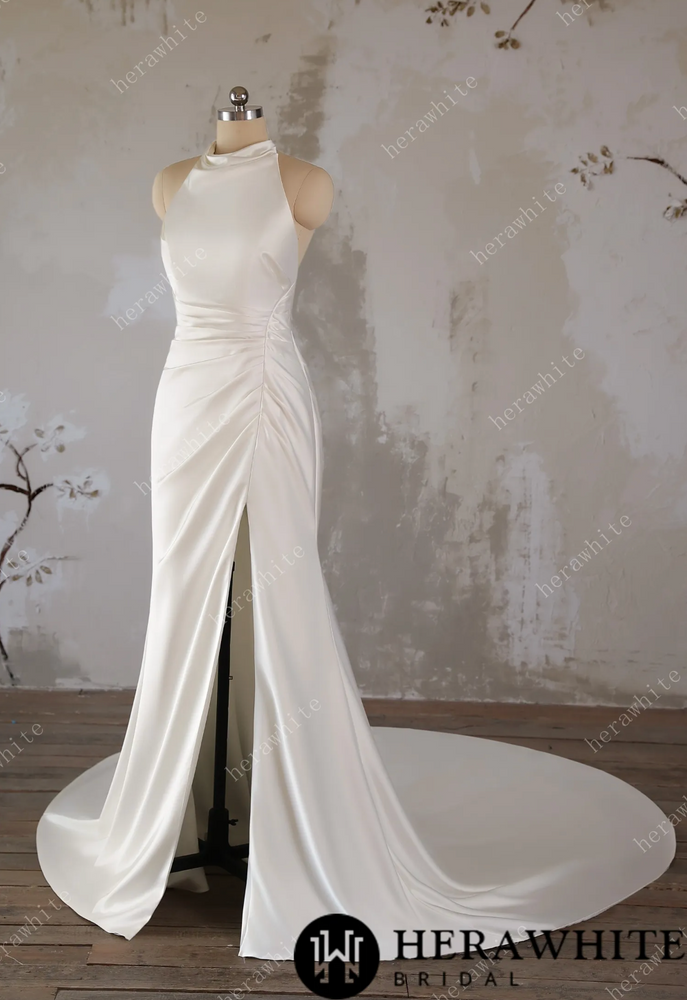 
                      
                        White wedding dress on a mannequin against a textured wall background
                      
                    