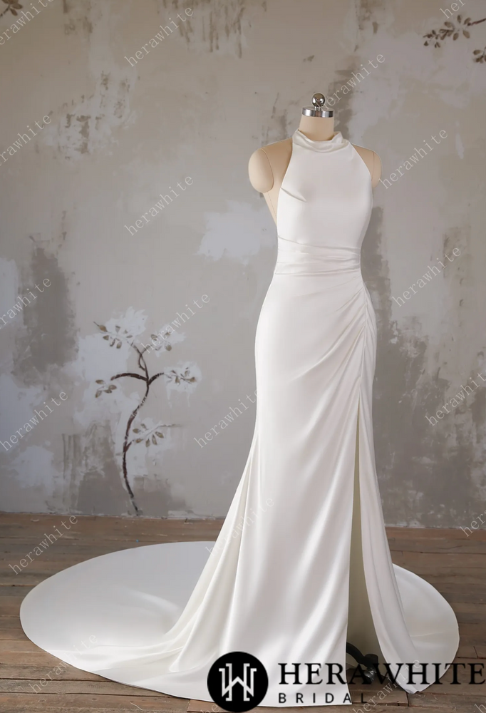 
                      
                        White wedding dress on a mannequin against a textured wall background
                      
                    