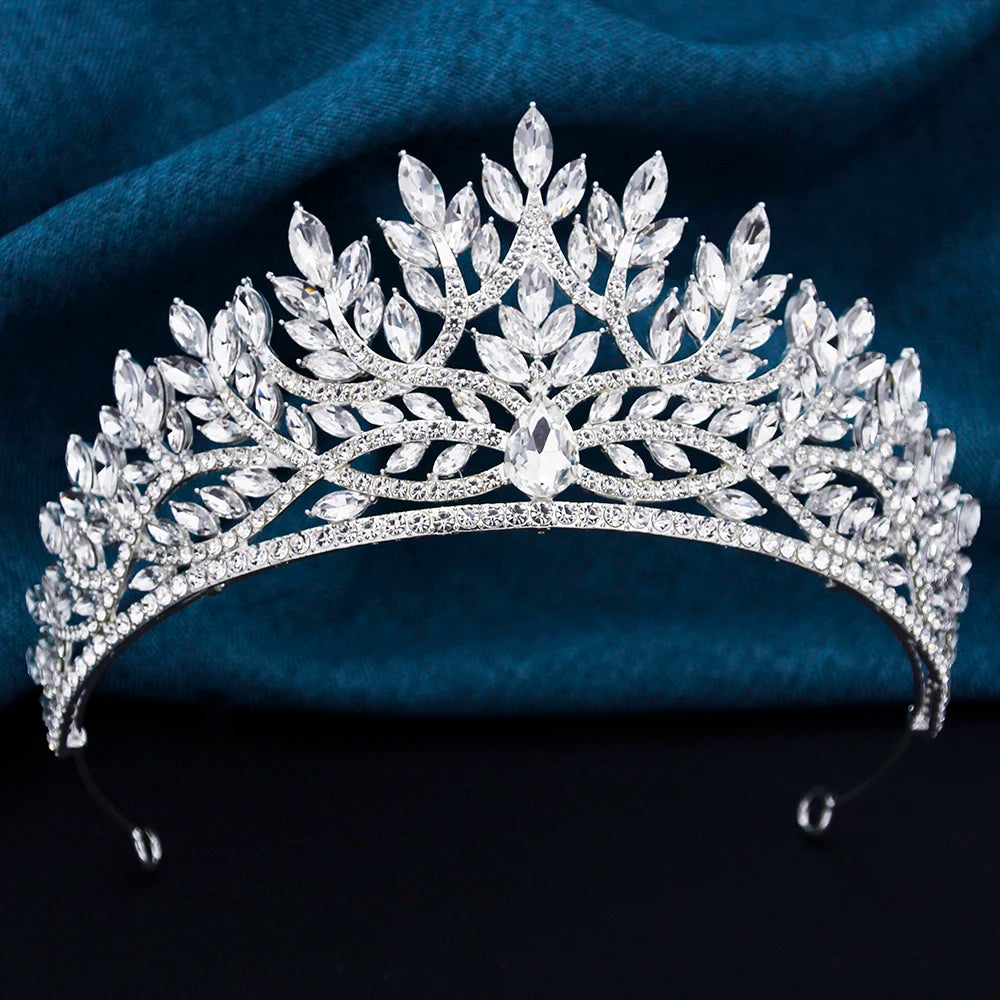 
                      
                        Silver tiara with clear stones on a dark blue fabric background
                      
                    