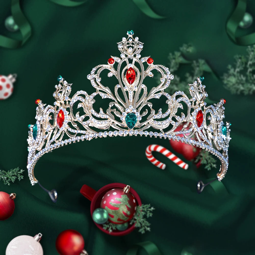 
                      
                        Decorative tiara with red and green gemstones on a festive green background with Christmas ornaments.
                      
                    