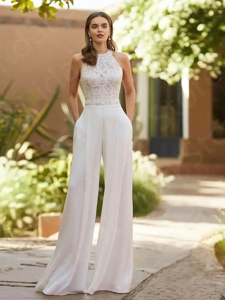 
                      
                        Woman wearing a bridal white lace halter top and wide-leg pants on a white background wedding jumpsuit
                      
                    