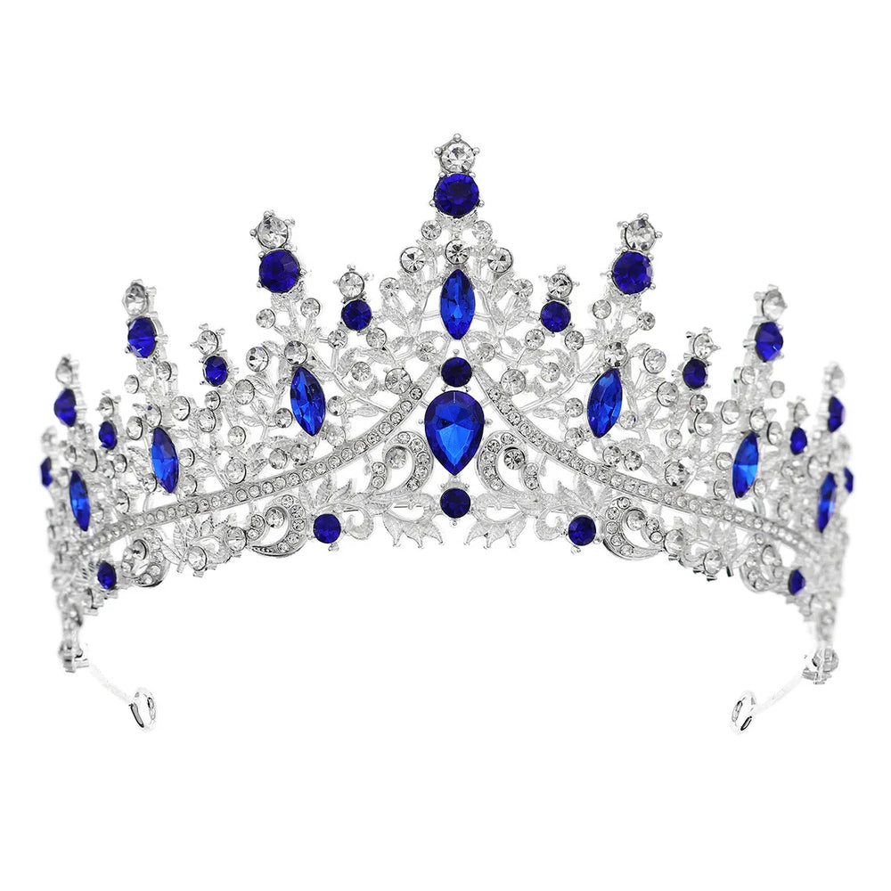 
                      
                        Elegant silver tiara with blue gemstones on a white background
                      
                    