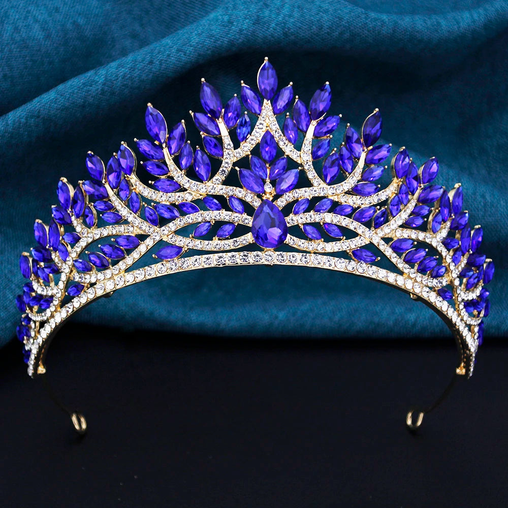
                      
                        Blue gemstone tiara on a dark blue fabric background
                      
                    