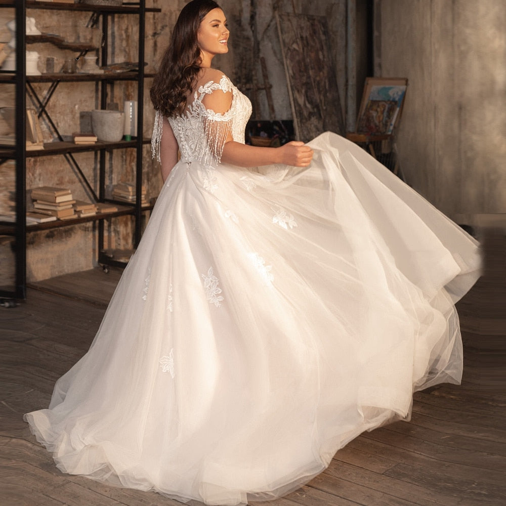 
                      
                        Sheer Neck A-line Bridal Gown Beaded Tassel Cap Sleeve Wedding Dress
                      
                    